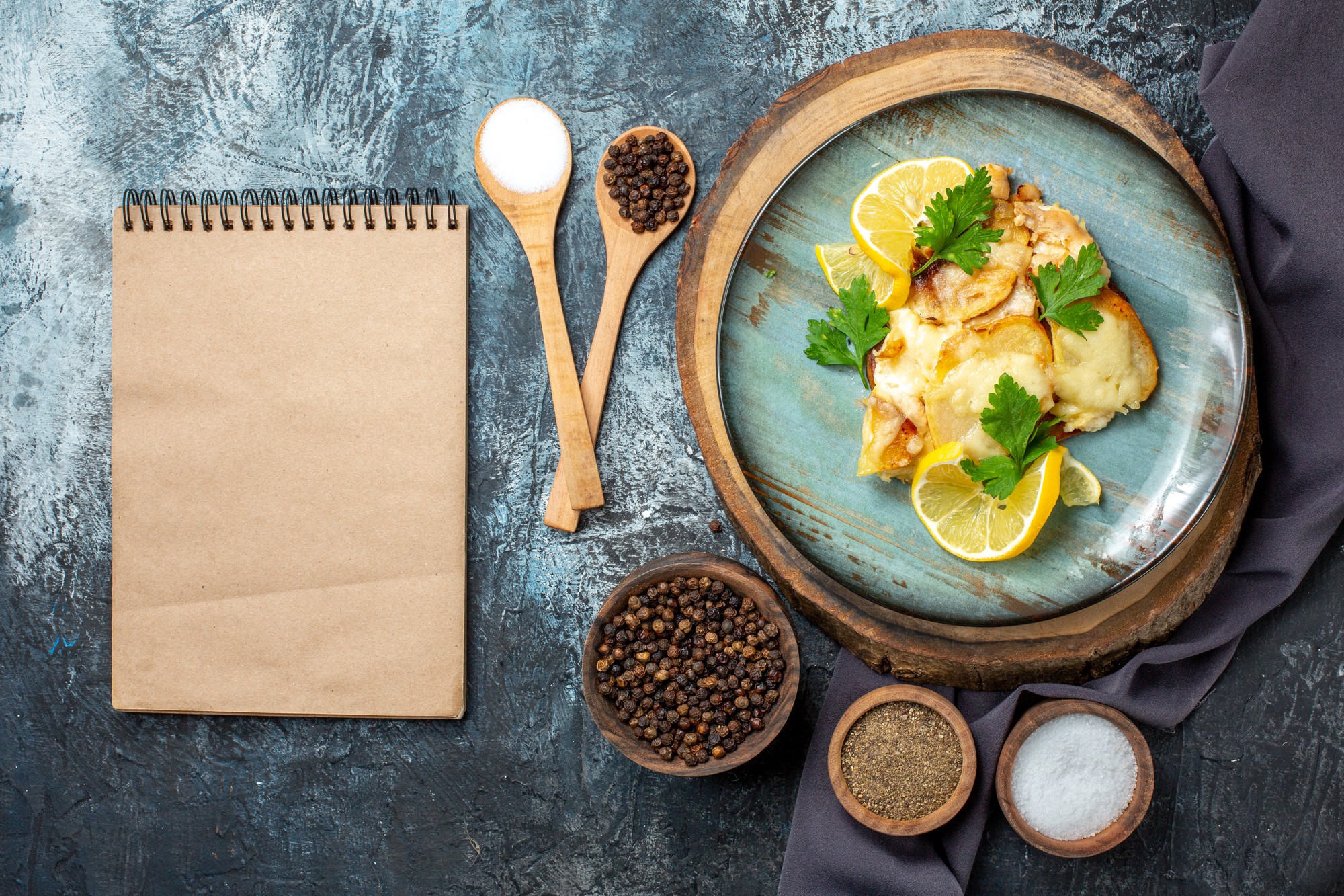 Close-up: plated dish and recipe notes on a wooden table