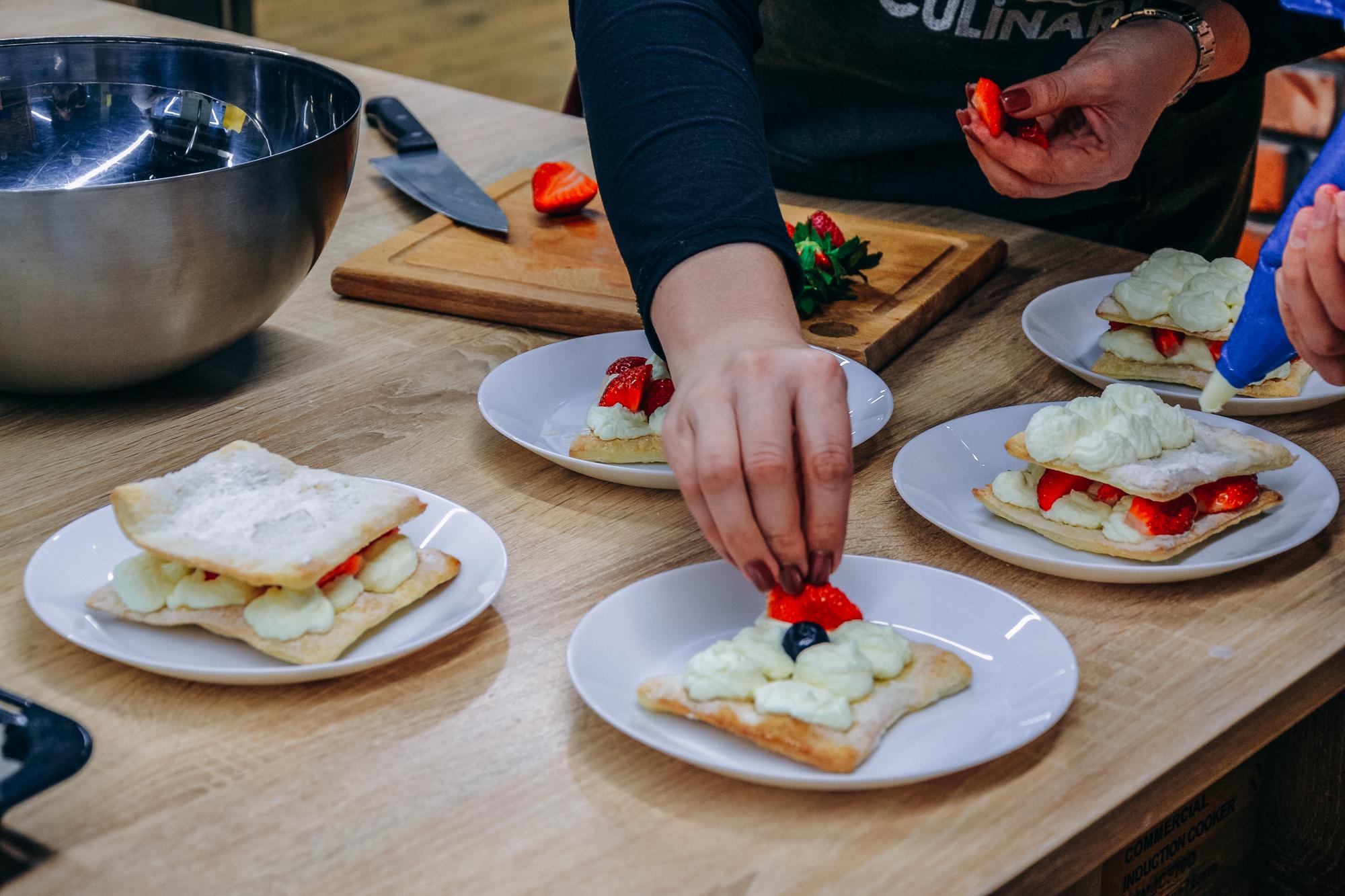 Student plating a dessert